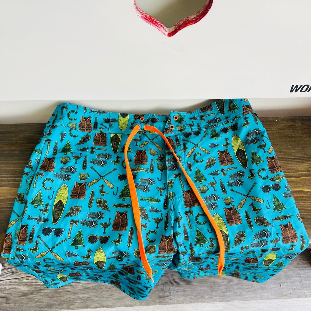 Turquoise Swim Shorts with Pattern and Orange Drawstring